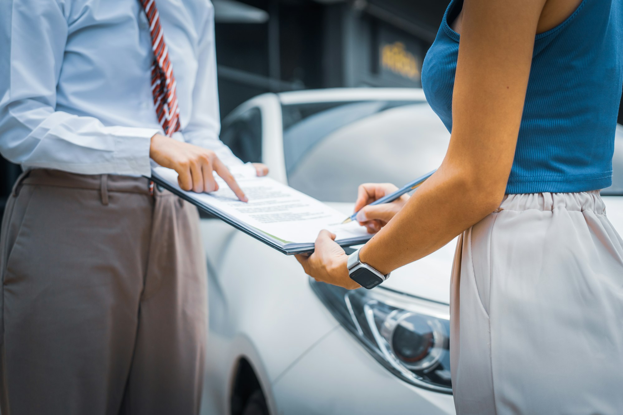A young businesswoman is navigating car insurance options at her desk, considering premiums