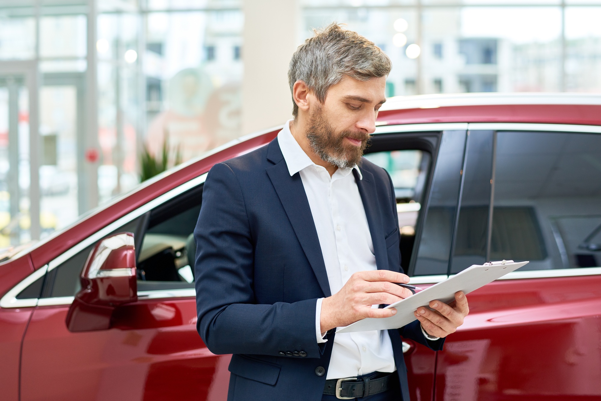 Mature Sales Assistant in Car Showroom